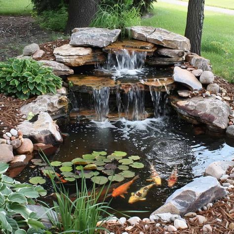 28 Stunning Koi Pond Waterfall Designs - Pond Informer Pond With Creek, Fish Pond Ideas Outdoors, Cool Pond Ideas, Backyard Waterfall Pond Ideas, River Rock Pond Backyard Waterfalls, Large Garden Ponds With Waterfalls, Landscape Ponds And Waterfalls, Landscape With Water Feature, Small Pond With Waterfall Ideas