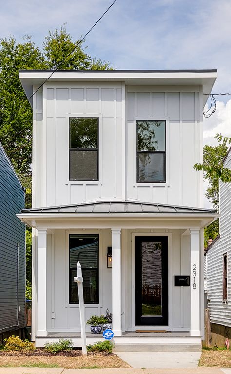 Narrow lot home This home is only 15 ft. wide so keeping the floor plan open and the design as as light and bright as possible was very important. We kept the exterior style of the home similar to the other homes on this block but we added the board and batten siding, white exterior paint, and black windows to give it an updated and on trend look. We made the front porch low to the ground to also give the home some southern charm #narrowlot #narrowhome #tinyhome #tinyhomes Narrow Modern Farmhouse Plans, Small Tall House Design, Narrow Lot Farmhouse Plans, Narrow Home Exterior, Narrow House Kitchen, Narrow Lot Modern House Plans, Open Concept Narrow House, Pasinaya Homes Design, Small House With Front Porch