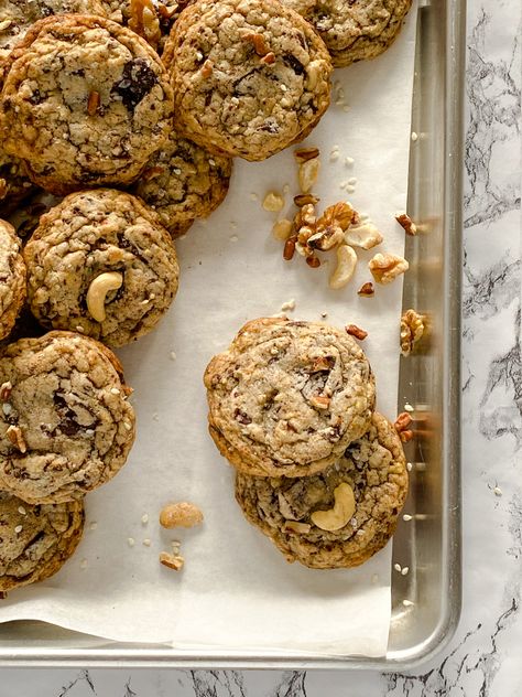 Soft and chewy chocolate chip cookies filled to the brim with chocolate chunks and a mixture of walnuts, pecans, cashews, and sesame seeds. #chocolatechipcookies #nutsandchocolate #recipe #dessert #cookies #cookierecipes #chocolate #nuts Toffee Chocolate Chip Cookies, Cookies And Bars, Chocolate Cookie Bars, Dessert Cookies, Toffee Cookies, Hot Chocolate Cookies, Walnut Cookies, Recipe Dessert, Chocolate Nuts