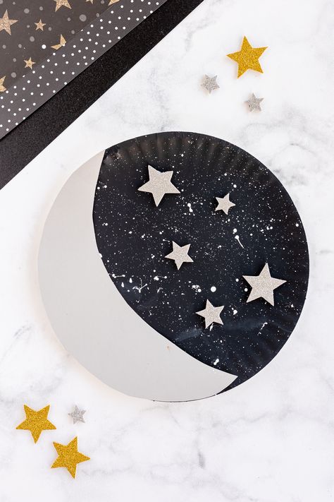 paper plate moon with stars nearby on craft counter Paper Plate Moon Craft, God Made Sun Moon And Stars Craft, Paper Plate Astronaut Helmet, Paper Craft Preschool, Crescent Crafts Preschool, Constellation Crafts Preschool, Sun And Moon Craft Preschool, Moon Craft Ideas, Space Toddler Crafts