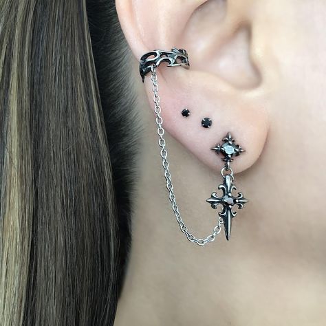 LISTING FOR 1 PIECE ONLY Gothic inspired Cross earring is attached with a chain to the Ear cuff.  Cuff part of the earring needs no piercing, just slide on the ear. This cuff fits both right and left ears.  Material:316 Stainless steel/ set with Black Cubic Zirconia stones Total earring length"  3 1/2"  Cuff :5.5 mm Cross stud:  25 mm *RETURNS / REFUNDS * -If you would like to return you purchase , please contact us within 7 days of receiving your package and we will accept the return.Return wil Gothic Ear Piercings, Silver And Black Earrings, Goth Earrings Aesthetic, Goth Ear Piercings, Gothic Piercings, Alt Earrings, Mens Earring, New Ear Piercing, Cross Earring