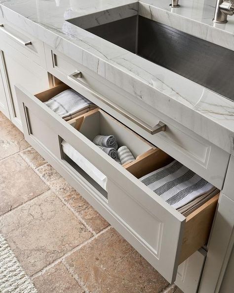 Organize your kitchen with a towel drawer under a stainless steel sink for an easy and organized finish. Glass Fronted Kitchen Cabinets, Towel Drawer, Custom Kitchen Drawers, Under Kitchen Sink, Grey Kitchen Island, White Shaker Kitchen, White Shaker Cabinets, Stainless Steel Sink, White Marble Countertops