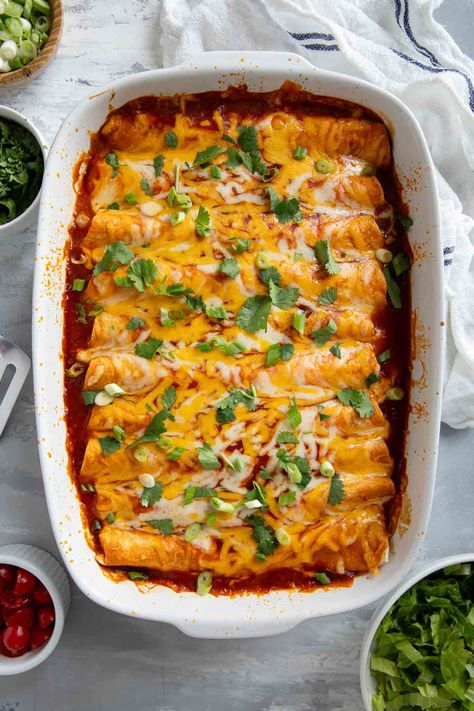 Filled with beef, refried beans, and cheese, these Ground Beef Enchiladas are a Tex-Mex favorite! These enchiladas only take a few ingredients, and are easy enough for a weeknight. Refried Beans And Cheese, Bean And Cheese Enchiladas, Gluten Free Enchiladas, Beans And Cheese, Mexican Enchiladas, Easy Beef Enchiladas, Ground Beef Enchiladas, Enchilada Ingredients, Bean Enchiladas