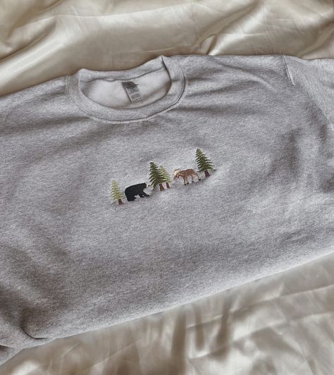 "Embroidered Bear and Moose Sweatshirt -Embroidered on a cotton/polyester blend crewneck sweatshirt, this design is simple and minimalistic, perfect for every outfit! -Embroidery design measures 1.25\" x 5\". -See product pictures for shirt sizing chart. **SWEATSHIRTS ARE IN UNISEX SIZING AND RUN TRUE TO SIZE. -All sweatshirts are handmade on an embroidery machine so there may be slight differences, but we only sell the sweatshirts that meet our high-quality standards. -To maintain the quality o Grey Sweatshirt Embroidery, Cute Sweatshirt Embroidery Ideas, Cute Embroidered Shirts, Machine Embroidered Clothes, Crew Neck Embroidery Ideas, Cute Embroidery Ideas Shirts, Machine Embroidery Tshirt, Embroidery Designs For Shirts, Embroidery Designs Sweatshirt