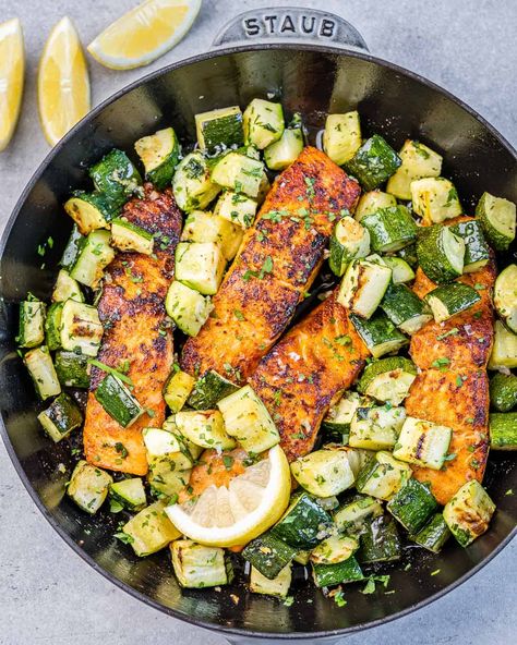 top view salmon filets cook on a black skillet with chunks of zucchini Squash And Salmon Recipes, Baked Salmon And Zucchini, Salmon With Zucchini And Squash, Salmon Low Cholesterol Recipes, Salmon And Squash, Salmon Zucchini Recipes, Salmon Chunks Recipe, Salmon And Zucchini Recipes, Salmon Squash