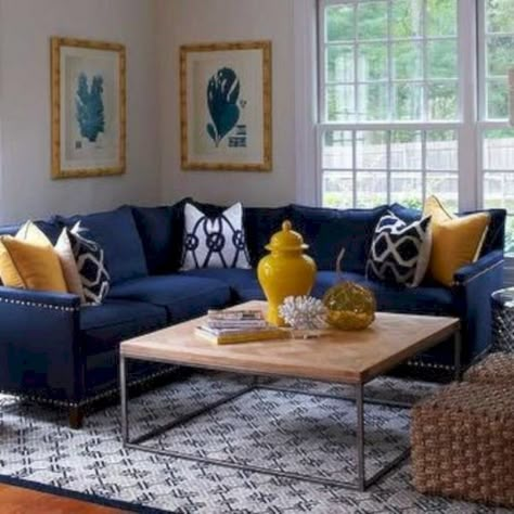 This room displays harmony because the room is able to use both warm and cool colors to use the same repetition of design and patterns throughout the space. Blue And Yellow Living Room, Blue Couch Living, Blue Sofa Living, Blue Sofas Living Room, Blue Couch Living Room, Navy Living Rooms, Furnitur Ruang Keluarga, Apartment Entryway, Trendy Apartment