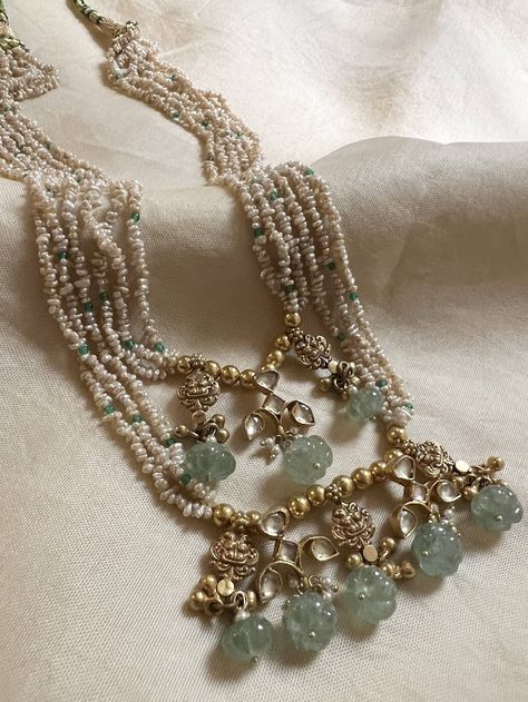 Layered pearl necklace with kundan stones and mint green pumpkin beads. Hand made by skilled artisans, Ciircular length of 23" aqnd comes with an adjustable back strap To view other silver jewelery, pls click on https://aavaranaa.com/silver-jewellery/ Pearl Necklaces Layered, Small Beaded Necklace, Green Pearl Necklace, Antique Pearl Necklace, Pumpkin Beads, Kundan Jewellery Bridal, Bridal Jewelery, Layered Pearl Necklace, Jewellery Bridal