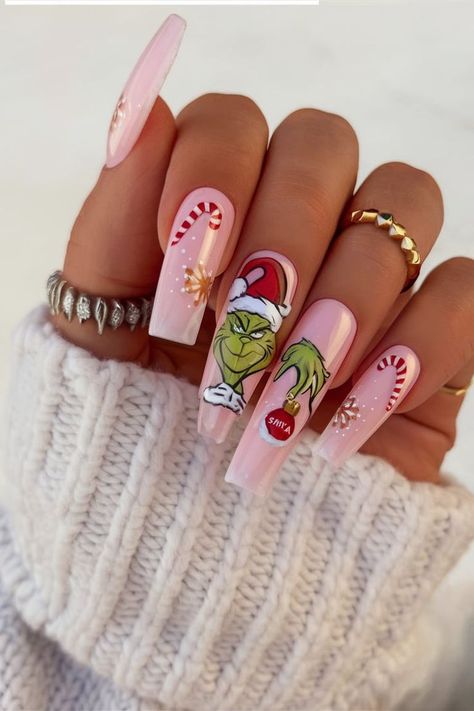 These soft pink nails bring a festive twist with candy cane details and a cute Grinch design. Adorned with snowflakes and holiday-themed art, this charming nail look is perfect for celebrating Christmas with a playful, feminine flair. Grinch Nails, Cute Christmas Nails, Christmas Nails Easy, Christmas Gel Nails, Nail Designs Valentines, Cute Gel Nails, Christmas Nails Acrylic, Manicure Ideas, Short Acrylic Nails Designs