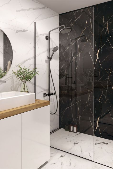 A bathroom with a walk in shower. The walls are clad in white marble with the shower wall clad in black marble. Toilet Tiles Design, Black And White Bathroom Floor, Black Marble Bathroom, Black Tile Bathrooms, Black And White Tiles Bathroom, Rental Bathroom, Marble Tile Bathroom, White Marble Bathrooms, Bathroom Design Black