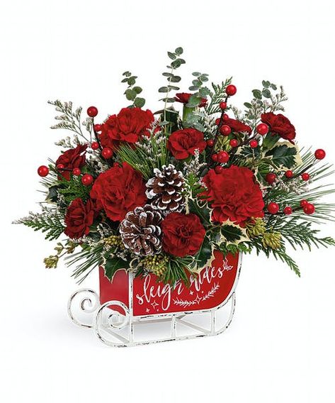 Dashing through the snow in a flower-filled open sleigh! Fun and festive, this vintage metal keepsake sleigh is the perfect vehicle for a joyful holiday bouquet. Red carnations, miniature red carnations and white filler are accented with assorted greens and evergreens and artistically arranged in Vintage Sleigh Ride Keepsake. Approximately 13 1/2" W x 12 1/2" H #FlowerKingdom Vintage Sleigh, Holiday Floral Arrangements, Holiday Bouquet, Holiday Flowers, Christmas Flower Arrangements, Red Carnation, Holiday Flower, Holiday Floral, Christmas Sleigh