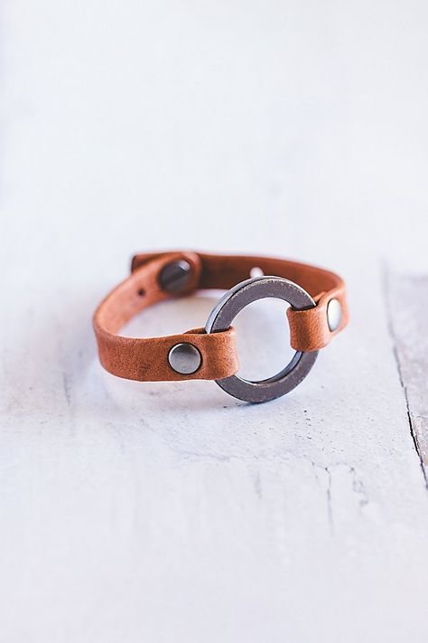 Designed to remind us that we all need to reconnect and ground to nature, our Grounding bracelet is handcrafted from the softest lamb leather and features a chunky antique silver ring with matching rivets. **Contents** * Lambskin leather, zinc alloy hardware * Button clasp closure * Handmade **Care/Import** * Made in the USA **Dimensions** * Adjustable to fit wrist sizes 6.5”-8” | Giving Bracelets Antique Silver Grounding Leather Bracelet at Free People in Orange Scrap Leather Projects, Leather Bracelet Diy, Arrowhead Bracelet, Boho Leather Jewelry, 2024 Creative, Leather Bracelet Tutorial, Leather Cord Jewelry, Handmade Leather Jewelry, Diy Leather Bracelet