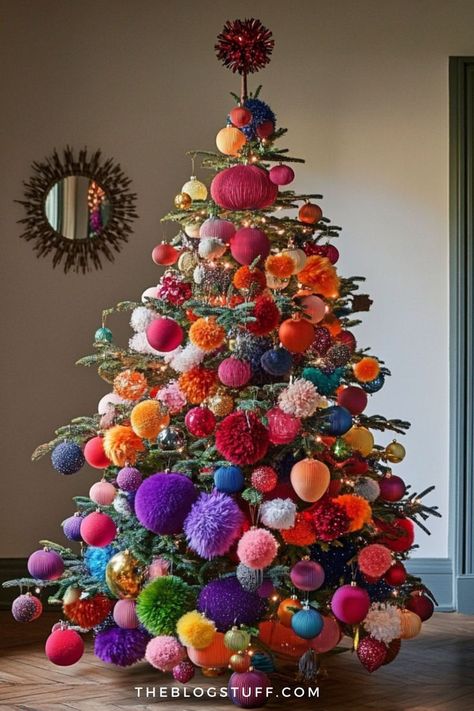 Colorful pompom Christmas tree decorated with bold ornaments in various shapes and textures. Tree Theme Ideas Christmas, Present Under Christmas Tree, Pompom Ornaments Christmas Tree, Colorful Xmas Decor, Whimsical Pencil Christmas Tree, Colorful Christmas Tree Ornaments, Craft Themed Christmas Tree, Irredescent Christmas Tree, Rainbow Tree Decorations