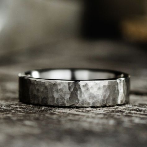 Discovered by American astronomer Scott Sheppard, Arche, a marvelous moon circling Jupiter inspired the design of this sleek, hammered titanium band. Our skilled artisans meticulously craft a unique moon-like hammered texture into each titanium ring. The ultra-durable, lightweight and hypoallergenic composition of titanium paired with a signature hammered finish, makes this wedding band an ideal choice for a timeless look and everyday wear. 6mm Titanium Hammered Ring Features:  Lightweight, dura Dark Titanium Wedding Band, Men’s Wedding Band Simple, Wedding Rings Masculine, No Stone Wedding Band, Woven Wedding Rings, Male Wedding Bands Unique, Simple Mens Rings, Wooden Mens Wedding Bands, Mens Titanium Ring