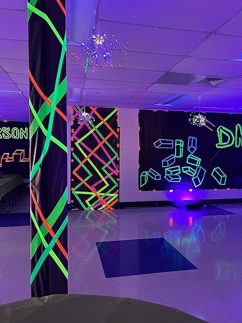 If you need neon party ideas, then you'll want to see this middle school dance decor! Throw a black and white party with glow in the dark tape, black school paper - it's an easy DIY party that glows in the dark! Glow In The Dark Theme Party Decoration, Glow In The Dark Hoco Ideas, Pole Decorations Ideas Party, Neon Nights Homecoming, Neon Party Ideas Decoration Diy, Rave Theme Party Decorations, Glow In The Dark Tape Ideas, Diy Dance Decorations, Glow Homecoming Theme