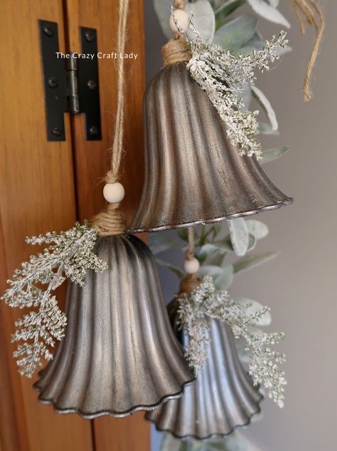 Make this DIY silver bell trio and transform plastic bells from the dollar store into high-end holiday decor Diy Jingle Bell Garland, Bundt Pan Christmas Crafts, Rustic Christmas Bells Diy, Silver Bells Christmas Party Theme, Vintage Christmas Store Displays, Dollar Store Winter Decor, Large Bells Christmas Decor, Diy Large Bells, Jingle Bell Wreath Diy