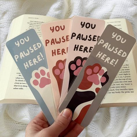 Happy #nationalbookloversday ! I’m so happy that I’m releasing my bookmarks on this day!!! Here’s one of my themes , I also have this available in doggy paws as well! These are completely handmade , hand drawn , and made with love! They’re laminated for extra protection as well 🩷 Share this with someone who loves cats!!! . . . #bookmarkshop #bookmarkart #catloverclub #bookishgirl #bookishart #bookloversofinstagram #bookstagram Laminate Bookmark, Book Marks Design Ideas, Cat Bookmark, Handmade Bookmarks Diy, Bookmark Ideas, Bookmarks For Books, Creative Bookmarks, Bookmark Craft, Doodles Drawings