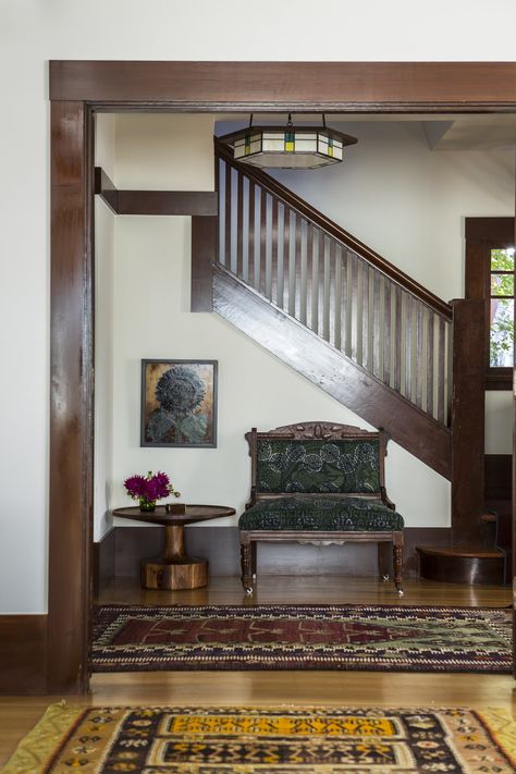 A vintage settee, antique rugs, a Blue Dot side table, and a custom chandelier lighten the mood in the house’s entry. Creamy White Walls, Reath Design, Craftsman Interior Design, Craftsman Home Interiors, Berkeley Homes, Alternative Seating, Dark Trim, Craftsman Interior, Craftsman Homes