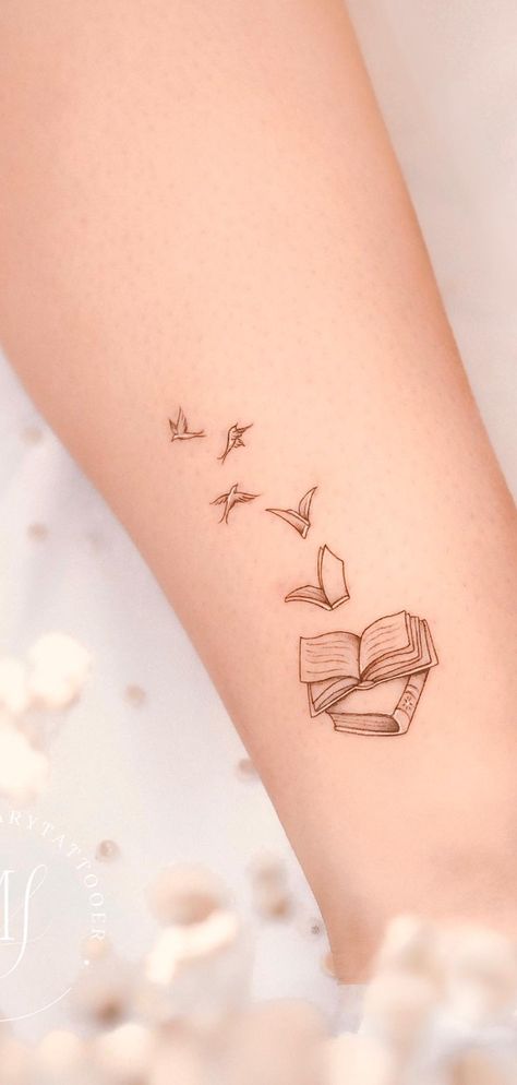 Beautiful book tattoos ideas for readers, tattoos for readers, meaningful tattoos, books tattoos, book tattoos tiny, book tattoos small, book tattoos sleeve, patchwork tattoos ideas, stack of books tattoos, book tattoos ideas simple, fine line art tattoo, book tattoos ideas small, meaningful literary tattoos for book lovers, book tattoos for literature lovers. Cute Small Book Tattoos, Small Reader Tattoo, Literary Quotes Tattoos, Verity Tattoo Designs, Bird Book Tattoo, Book To Bird Tattoo, Cute Book Tattoos For Women, Heart Book Tattoo, Bird And Book Tattoo