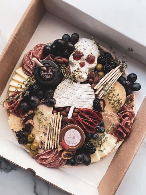 Halloween Cheese Platter Ideas, Halloween Snack Platter Ideas, Dark Cheese Board, Skull Brie Cheese, Pirate Themed Charcuterie Board, Coffin Shaped Charcuterie Board, Halloween Grazing Board Ideas, Halloween Charcuterie Box Ideas, Spooky Grazing Table