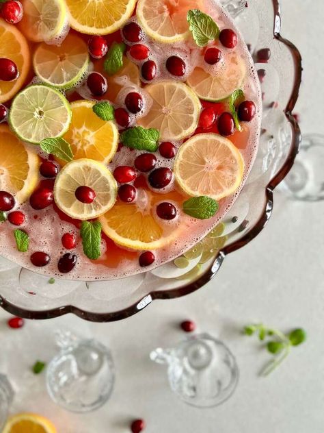 This Christmas morning punch is garnished with floating slices of orange, lemon and lime, and sprinkled with fresh cranberries and mint leaves. This brunch punch delights in delicious fruity flavor. #fromhousetohaven #christmasmorningpunch #brunchpunch #christmaspunch #punchrecipe #brunchrecipe #drinkrecipe Grace In My Space, Christmas Morning Punch, Christmas Morning Brunch, Brunch Punch, Cranberry Juice Cocktail, Christmas Punch Recipes, Morning Brunch, Holiday Punch, Peanut Butter No Bake