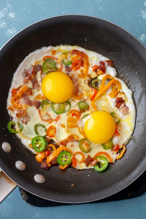 This is a fun twist on classic eggs breakfasts. It's half omelet, half scramble, and half sunny-side up egg! And yes, that adds up to 150% because it's that good! Plus, it's ready in just a few minutes! Bacon, sweet peppers, garlic, and my secret ingredient: parmesan cheese! macheesmo.com #eggs #breakfast #easyrecipes #omelettes Sunny Side Up Egg Recipes, Egg Sunny Side Up, Sunny Side Up Eggs Breakfast, Sunny Side Up, Best Egg Breakfast, Sunny Side Up Eggs Recipe, Eggs Breakfast Ideas, Omelette Toast, Body Regeneration