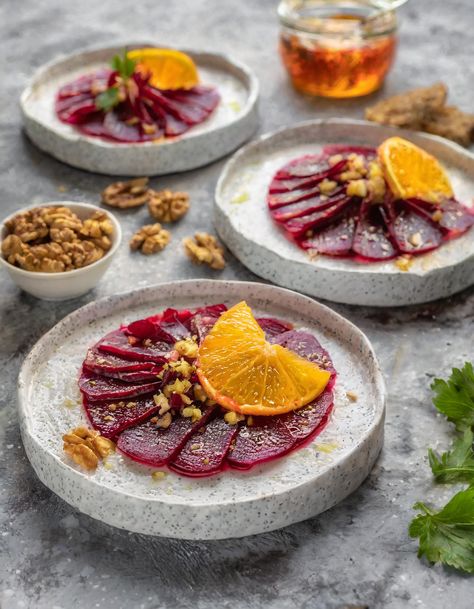 Savor the vibrant colors and fresh flavors with this Beet Carpaccio with Orange Vinaigrette, an elegant starter that pairs the earthy sweetness of beets with a zesty orange dressing. Topped with toasted walnuts, this dish offers a delightful crunch and nuttiness that complements the soft texture of the beets perfectly. Beet Salad Plating, Starter Dishes Appetizers, Pickled Beet Appetizer, Fine Dining Recipes Vegetarian, Beet Cured Salmon, Vegan Michelin Recipes, Beetroot Carpaccio Fine Dining, Amous Bouche Ideas, Beetroot Canapes