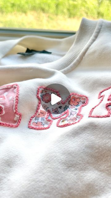 Stitchin With Samantha | Embroidery Patterns & Kits on Instagram: "Using Olive’s old newborn onesies to make a MAMA sweatshirt 🪡✨   I am obsessed with how this turned out and I can’t wait to wear it all the time as a keepsake for her earliest days!🥹  I have been wanting to make a onesie sweatshirt for a year now, but I was too scared to make it with a sewing machine. I was inspired by @flynn_and_mabel to try out reverse appliqué and this technique was perfect for this project!!" Embroidery On Sweatshirts Words, Hand Stitched Embroidery Shirt, Reverse Embroidery Sweatshirt Diy, Felt Embroidery Sweatshirt, How To Applique With Embroidery Machine, Diy Star Sweatshirt, Sewing On Sweatshirts, Reverse Embroidery Sweatshirt, Diy Mama Sweatshirt