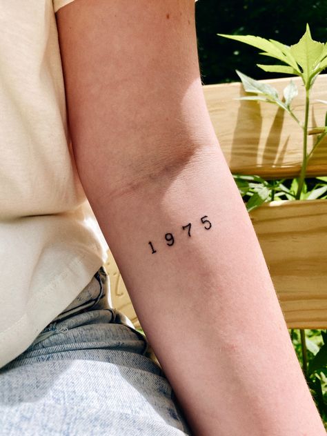 #1975 #the1975 #1975tattoo #tattoos #tattoosforwomen #armtattoo #womansleevetattoo #minimalisttattoos #hipstertattoos #yeartattoo #aesthetictattoos 1998 Small Tattoo, 1975 Number Tattoo, 1968 Tattoo Font, Small Years Tattoo, Tattoo Ideas Female Birth Year, 1983 Tattoo Ideas, Year Tattoo On Arm, 1965 Tattoo Number, 1973 Tattoo Ideas