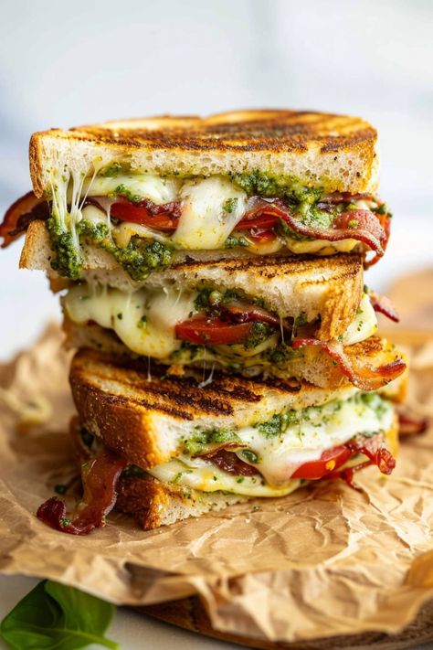 This pesto grilled cheese sandwich is a fun twist on an American classic. And it's so tasty, you might never make regular grilled cheese again! Grilled Cheese With Meat Recipes, Grilled Cheese With Arugula, Reuben Grilled Cheese, Caprese Grilled Cheese Sandwich With Pesto, Salami Grilled Cheese Sandwiches, Sourdough Open Sandwich Ideas, Grilled Ricotta Cheese Sandwich, Best Grilled Sandwiches, Delicious Grilled Cheese