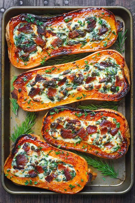 stuffed butternut squash with spinach, bacon, and cheese on a baking sheet Healthy Stuffed Butternut Squash, Spinach Stuffed Squash, Chicken Stuffed Butternut Squash Recipes, Sunday Winter Dinner Ideas, Squash Boats Stuffed, Stuffed Butternut Squash Recipes, Stuffed Pumpkin Recipes, Fall Sunday Dinner Ideas, Butternut Squash With Spinach