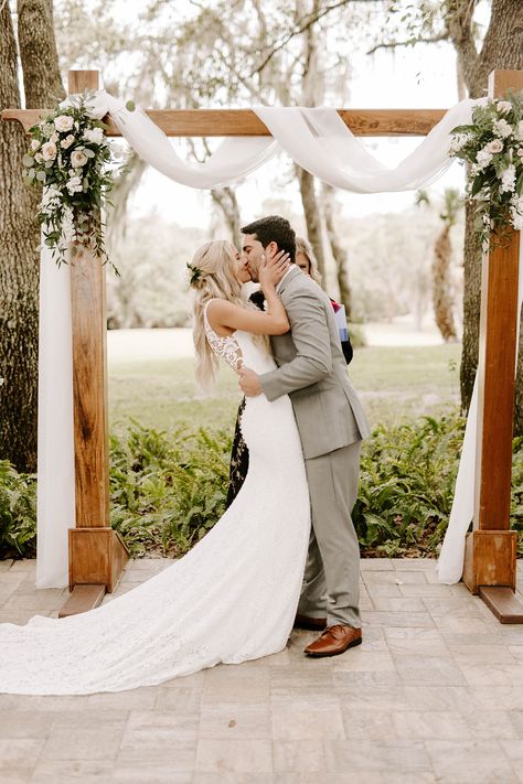 This couple wow'ed the crowd at this simple and elegant outdoor ceremony. Boho Greenery Wedding Arch, Simple Boho Wedding Arbor, Simple Floral Wedding Ceremony, Elegant Wedding Ceremony Outdoor, Simple Wedding Arches Outdoors, Wedding Arbor Simple, Simple Chuppah Ideas Outdoor, Wedding Trellis Ideas Arches, Simple Wedding Ceremony Backdrop