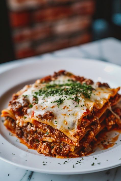 Indulge in a comforting homemade lasagna tonight with this delicious recipe! Layers of tender pasta, rich meat sauce, and creamy cheese make this classic dish an irresistible crowd-pleaser. Whether you're cooking for the family or hosting friends, lasagna is always a hit. Follow this simple recipe to create a mouthwatering lasagna that will have everyone asking for seconds. Enjoy the savory flavors and hearty goodness of lasagna - perfect for any occasion! Lasagna And Salad, Italian Dinner For Two, Dinner Recipes Friends, Lasagna Photography Food Styling, Lasange Recipe Classic, Meaty Lasagna Recipe, Lasagna Meat Sauce Recipe, Christmas Pasta Recipes, Fancy Food Ideas