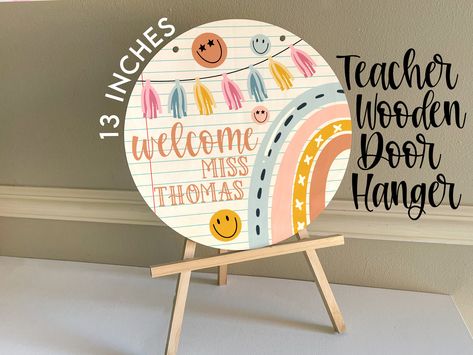 Custom personalized Classroom Decor Teacher Wooden Door Hanger! A perfect touch to your classroom or a special gift for your favorite teacher!  ABOUT OUR DOOR HANGERS: + Our signs are single sided prints and the back will be left blank + They measure 13 inch in diameter + They come ready to hang with red ribbon! CUSTOM DESIGNS:  Any color changes, font changes, wording changes, etc. to a design are custom changes. These are CUSTOM designs and need to be ordered from us under a custom listing sin Kindergarten Door Hanger, Door Hanger For Classroom, Teacher Signs For Classroom Door, Teacher Circle Door Hanger, Boho Teacher Door Hanger, Teacher Classroom Door Signs, Classroom Signs Wooden, Teacher Wooden Door Hangers, Boho Teacher Sign