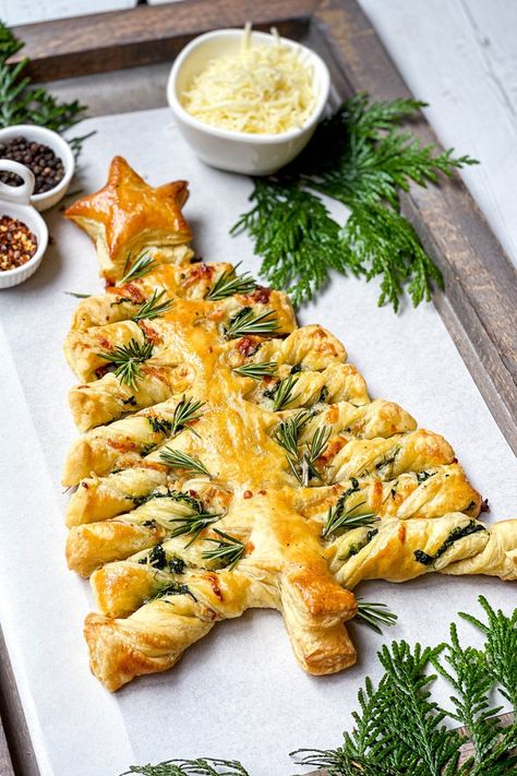 It's the festive season and this Spinach Puff Pastry Christmas Tree is savory treat you, your family, and guests will love. Simple to make with a cheesy spinach filling, store-bought puff pastry and pizza sauce for serving. Spinach And Cheese Christmas Tree, Christmas Tree Pillsbury Dough, Christmas Tree Puff Pastry Spinach, Savoury Puff Pastry Christmas Tree, Christmas Tree Pastry Spinach, Puffy Pastry Christmas Trees, Christmas Dinner Recipes Appetizers, Spinach Artichoke Pastry Puffs, Spinach Puff Pastry Christmas Tree