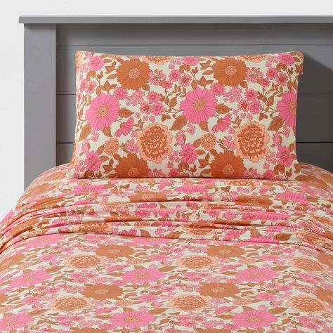 Transform your teen's bedroom into a blooming sanctuary with the Printed Jersey Sheet Set. Featuring a vibrant floral print in shades of pink and peach against a white ground, these jersey sheets will add a pop of color and personality to their space. Crafted from a blend of recycled polyester and cotton, offering both comfort and sustainability. 4-piece full and queen sets include a flat sheet, fitted sheet and two pillowcases; 3-piece twin set includes a flat sheet, fitted sheet and one pillow Full Duvet Cover Set, Earthy Pink Bedroom, Indy Bedroom, Pink Adult Bedroom, Pink Western Bedroom, Pink And Orange Bedroom, Teen Curtains, Witchy Bedroom, Coral Bedroom