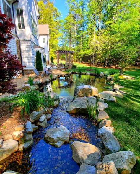 22 Inspiring Backyard Pond Ideas - gramydeco River Rock Pond Backyard Waterfalls, Stock Tank Pond Waterfall, House With Stream, Diy Backyard River, Backyard Ponds Small Garden Waterfall, River In Backyard, Backyard Stream Landscaping, Frog Ponds Backyard, Natural Pond Landscaping