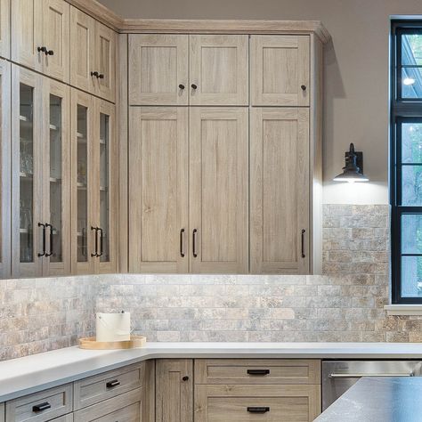 Finish the look with dark hardware and light fixtures. Beachwood Cabinets Kitchen, Duraform Drift Cabinets, Driftwood Cabinets Bathroom, Cabinet Finishes Wood, Driftwood Color Cabinets, Wood Grain Cabinets Kitchen, Driftwood Cabinets Kitchen, Driftwood Kitchen Cabinets, Bleached Wood Kitchen Cabinets