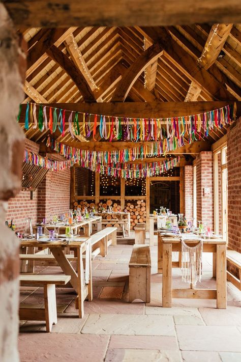 Colourful barn wedding reception with wooden tables and benches and colourful streamers. Grace Loves Lace Wedding Dress, Wedding Dress Outdoor, Bucking Bronco, Colourful Wedding, Rainbow Wedding, Camp Wedding, Summer Wedding Colors, Rock My Wedding, Grace Loves Lace