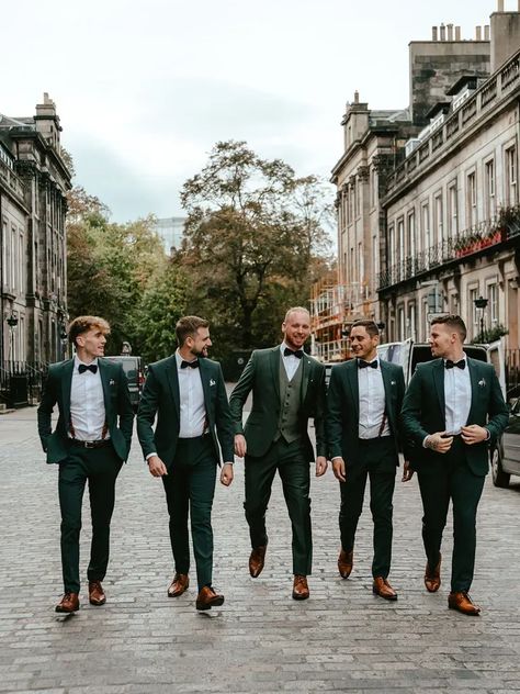 menswear vests and suspenders for your 2024 wedding inspiration Green Suit Men Wedding Groomsmen, Dark Green Groom Suit Grey Groomsmen, Deep Green Groom Suit, Wedding Green Suits Men, Black Green Groomsmen Attire, Groom And Groomsmen Attire Emerald Green, Green Groomsman And Bridesmaid, Dark Green Tuxedo Wedding Groom Style, Green Suit For Wedding Groom