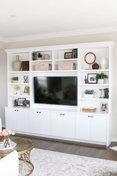 These white built-ins in this blush family room have lots of storage and room for accessories White Built Ins, Built In Shelves Living Room, Living Room Wall Units, Living Room Built Ins, Living Room Entertainment Center, Living Room Entertainment, Entertainment Center Decor, Neutral Living Room, Living Room Cabinets