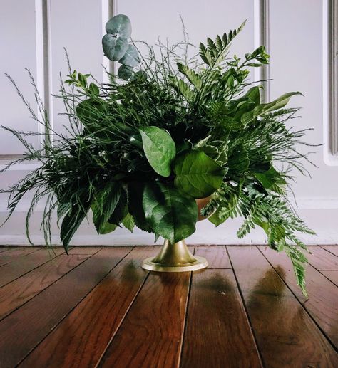 Greenery in lux gold compote featuring leather leaf, eucalyptus, and tree fern as a lush wedding table centerpiece. Green Table Arrangements, Centerpieces Greenery, Greenery Only Centerpiece, Foliage Table Centerpieces, Leaves Centerpiece, Green Plant Centerpieces, All Greenery Wedding Centerpieces, All Greenery Arrangements, Foliage Centerpiece Wedding