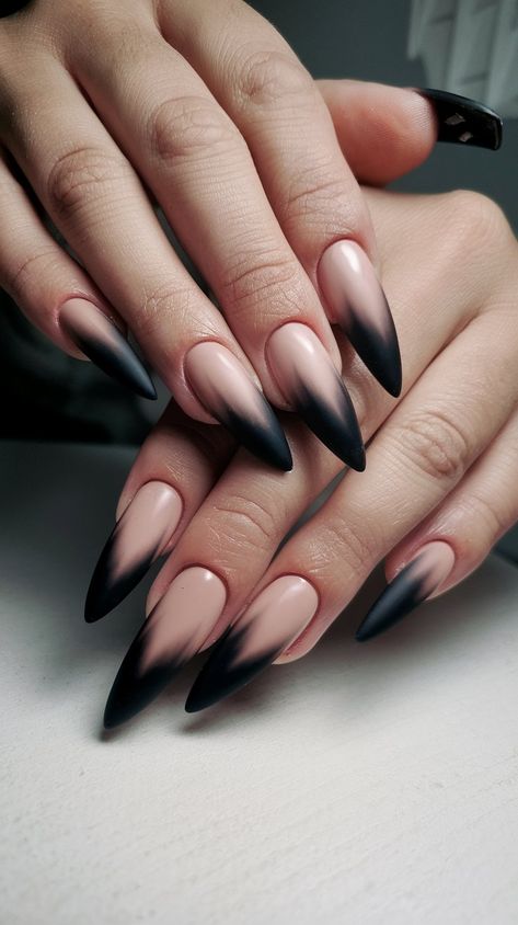 Elevate your nail game with these stunning stiletto acrylics! Featuring a sophisticated beige base that transitions into a sleek black matte gradient, these long nails exude elegance and modern flair. Perfect for any occasion, from a night out to professional settings, they’ll make your fingertips the center of attention. Show off this chic design on a clean white surface for a truly striking look! #acrylicnails #nailsdesign #octobernails ##nailsinspo Nude Stilleto Nail Ideas, Mat Black Nail, Dark Pointy Nails, Black Sweater Nail Designs, Dark Christmas Nails Almond, Goth Ombre Nails, Goth Style Nails, Nosferatu Nails, Nude And Black Nails Almond