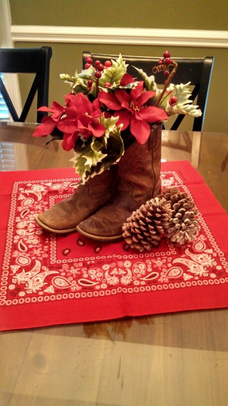 Cowboy Christmas boot centerpiece Texas Themed Christmas Decorations, Cowboy Christmas Table Decorations, Western Xmas Decor, Cowboy Boot Christmas Decor, Christmas Western Decorations, Cowboy Themed Christmas Party, Western Christmas Centerpiece Ideas, Christmas Western Decor, Cowboy Christmas Centerpieces