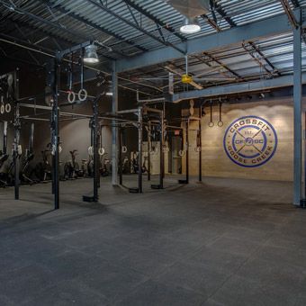 Shortly after purchasing the mats and before officially opening the doors to CrossFit Goose Creek, a gym owner from Nashville who was in a similar situation came over to witness the test.  “I was slamming a 135-pound barbell as hard as I possibly could from overhead,” Gray said, and the other gym owner said the sound was barely audible.  “We’ve been crashing weights on it for almost a month now, and I’ve been talking with my neighbors. They’re like, ‘We don’t hear anything,’” Crossfit Gym Design Ideas, Crossfit Gym Design, Crossfit Box Design, Warehouse Gym Design, Barn Gym, Crossfit Garage Gym, Rubber Gym Flooring, Warehouse Gym, Boutique Gym