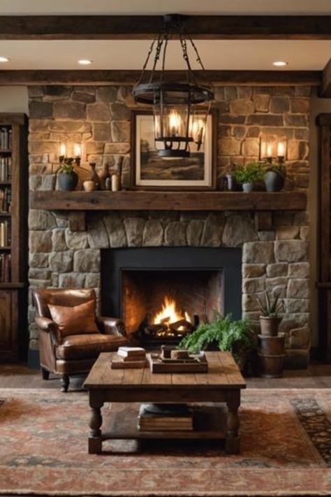 Cozy living room with stone fireplace, leather armchair, and wooden coffee table. Vintage Living Rooms Ideas, Yellowstone Inspired Living Room, Moody Modern Rustic Home, Earthy Moody Living Room, Warm Inviting Living Rooms, Moody Rustic Living Room, Black Rustic Living Room, Rustic Living Room Inspiration, Dark Rustic Living Room