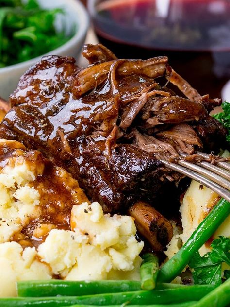 Slow Cooker beef short ribs. Fall-apart beef served with a rich and red wine gravy. This is serious comfort food. #shortribs #beefshortribs #comfortfood #dinnertonight #winterfood #SlowCooker #slowcooked #Beef #Crockpot #Recipe #glutenfree #glutenfreedinner Beef Ribs Slow Cooker, Short Rib Recipes Crockpot, Short Ribs Crock Pot, Beef Red Wine, Slow Cooker Beef Short Ribs, Boneless Beef Ribs, Meals Crockpot, Boneless Short Ribs, Boneless Beef Short Ribs