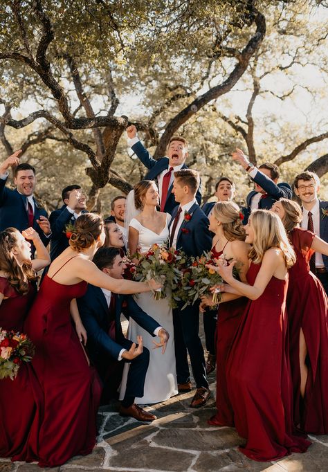 Fun excited wedding party surrounding bride and groom on wedding day wearing red bridesmaid dresses and groomsmen in blue suits Burgundy And Burnt Orange Wedding, Orange And Navy Blue Wedding, Trending Bridesmaid Dresses, Burnt Orange And Navy Blue, Bridesmaid Dresses Burgundy, Deep Red Wedding, Wedding Colors Red, Red Wedding Theme, Wedding Color Combos