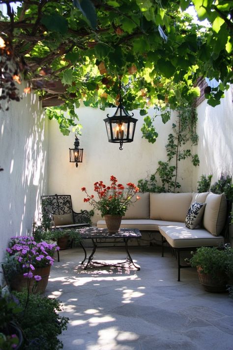 Outdoor patio with a cozy seating area, lush plants, and hanging lanterns. Diy Backyard Christmas Decor Ideas, Back Porch Awning Ideas, Simple Outdoor Seating Area, Simple Diy Backyard Ideas, Small Yard Decorating Ideas, Very Small Yard Ideas, Outside Spaces Ideas Backyards, Balcony Outdoor Ideas, Small Back Yard Ideas On A Budget Easy Diy Projects