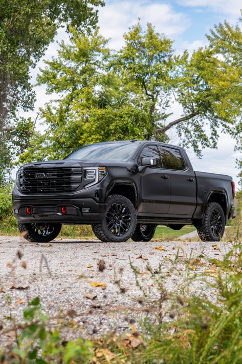 Full view of a 2024 GMC Sierra Denali truck with chrome delete trim, a satin black vinyl wrap, and a lift kit. Gmc Sierra Blacked Out, Custom Gmc Sierra 1500, Gmc Sierra Denali Lifted, Black Gmc Truck, Lifted Gmc Sierra 1500, Black Gmc Sierra, Gmc Sierra Lifted, Gmc Truck Accessories, Gmc Denali Truck