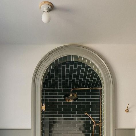 Alexander James Tile Studio on Instagram: "An arched opening creates a dream destination in this moody shower from @corey.lohmann.design. Matching the tone of the rich green tile to the millwork brings it full circle.⁣ ⁣ 𝗦𝗵𝗼𝗽 𝗢𝘂𝗿 𝗦𝗶𝗺𝗶𝗹𝗮𝗿 𝗦𝘁𝘆𝗹𝗲𝘀: Makoto Midori Green 2x10 Matte Ceramic 𝘭𝘪𝘯𝘬𝘦𝘥 𝘪𝘯 𝘣𝘪𝘰⁣ ⁣ ⁣⁣⁣⁣⁣⁣#AlexanderJames | Design: @corey.lohmann.design | Photography: @margaretrajic⁣ ⁣ #tile #ceramictile #tilestyle #lonnyliving #interiordesign #homerenovation #interior123 #bhilivebeautifully" Green Subway Tile, Beautiful Bathroom Designs, Porcelain Wall Tile, Stunning Bathrooms, Green Tile, Traditional Modern, Green Bathroom, Beautiful Bathrooms, Shower Doors